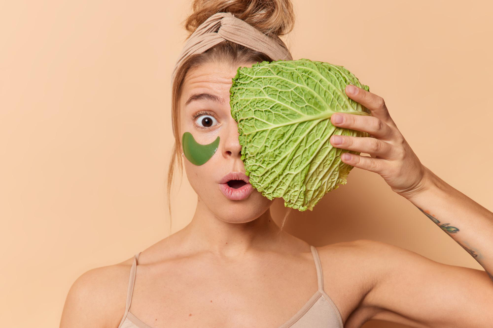Amazed Surprised Woman Holds Breath Feels Amazed Holds Fresh Cabbage Face Applies Hydrogel Patches Eyes Remove Wrinkles Undergoes Beauty Procedures Isolated Beige Background