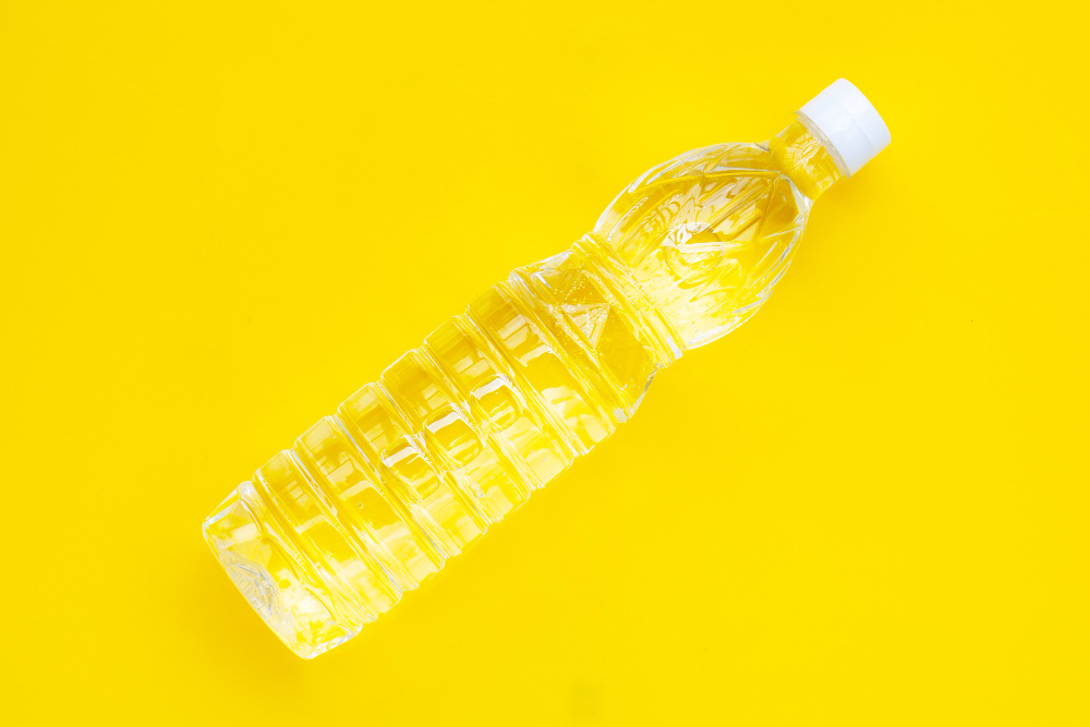 white-vinegar-bottle-yellow-background