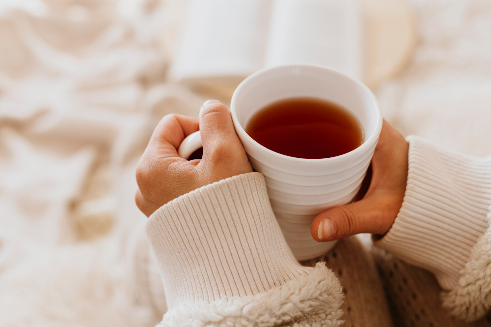 Young Woman Holding Cup Tea While Enjoying Winter Holidays