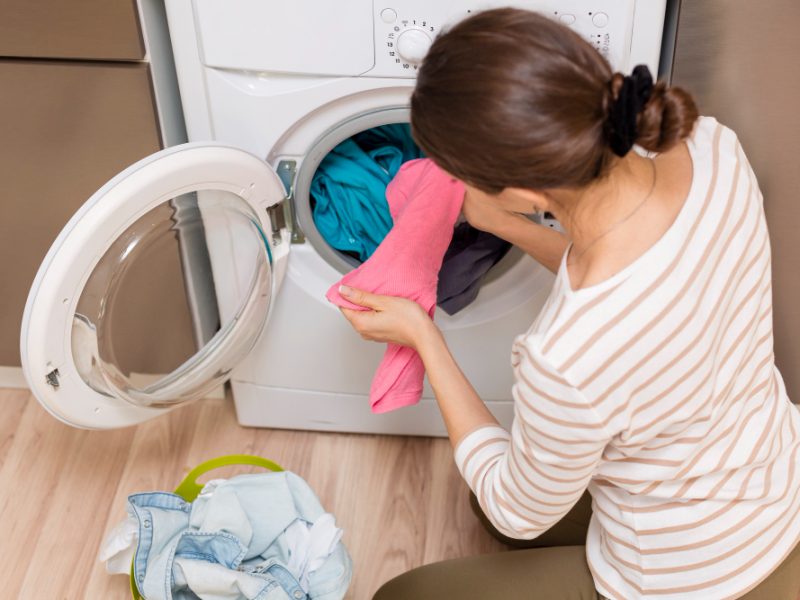 Lady Taking Clothes Out Washing Machine