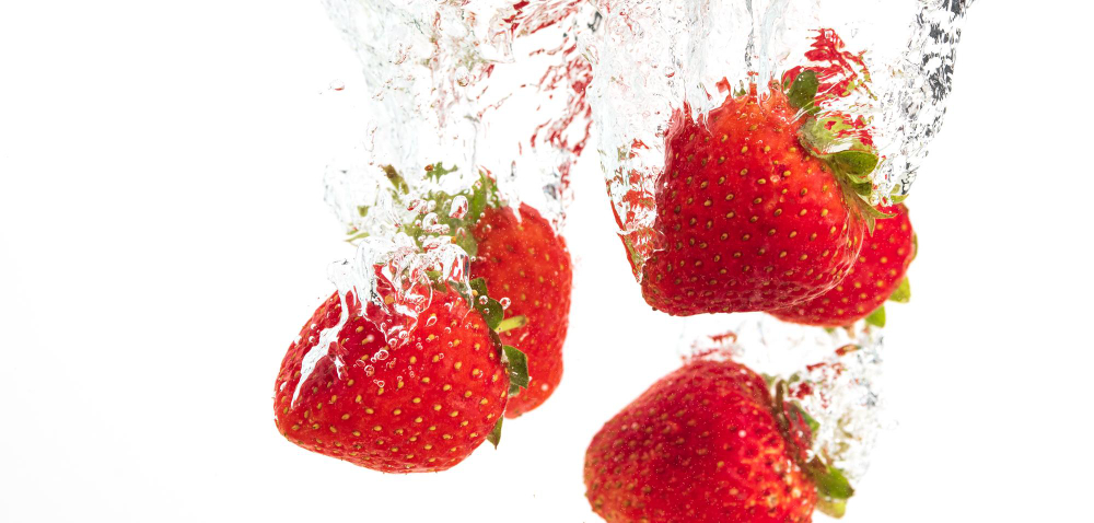 Strawberries Falling Into Water Causing Bubbles All Around It Healthy Food Concept