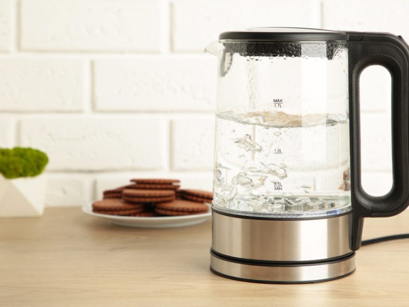 Glass Electric Kettle With Boiling Water Chocolate Chip Cookie White Background Top View
