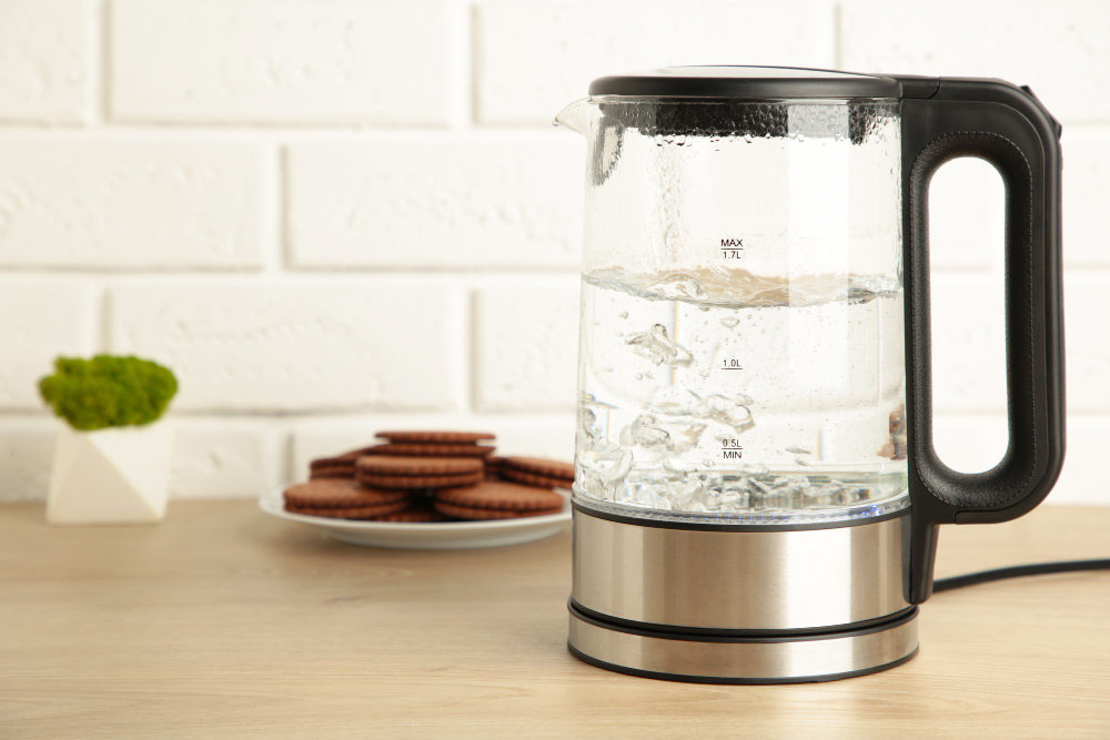 Glass Electric Kettle With Boiling Water Chocolate Chip Cookie White Background Top View