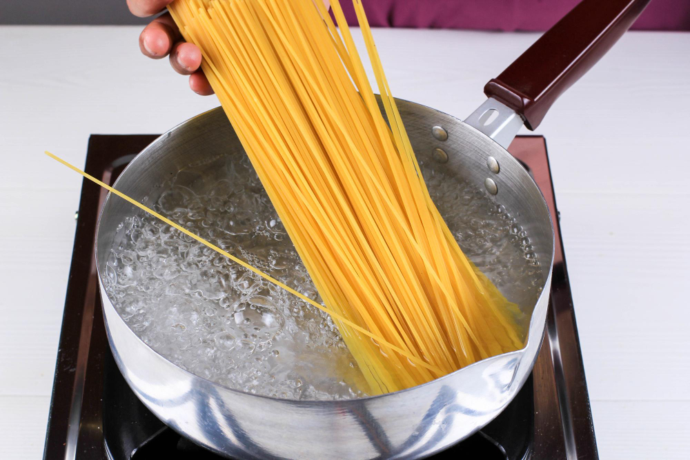 women-cooking-spaghetti-pan-boiling-water-kitchen