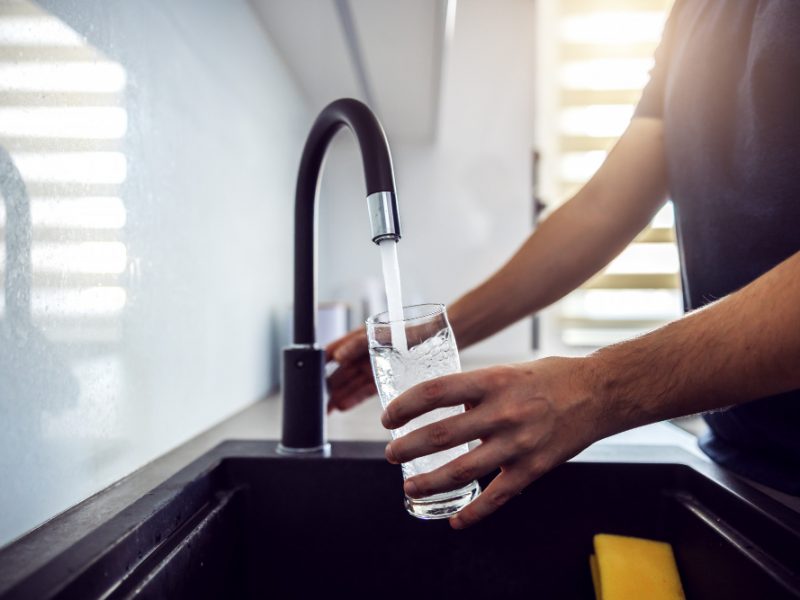 Close Up Young Man Pouring Fresh Water From Kitchen Sink Home Interior