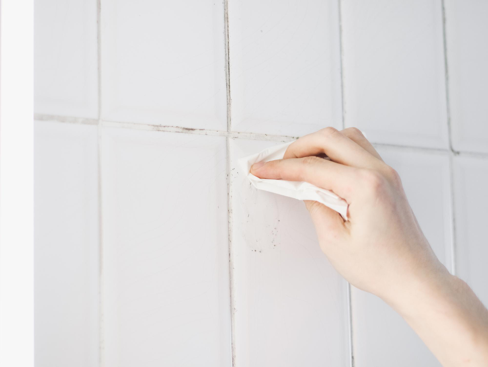 Hands Young Caucasian Guy Are Wiping Halfdried Silicone With Napkin Tile Wall