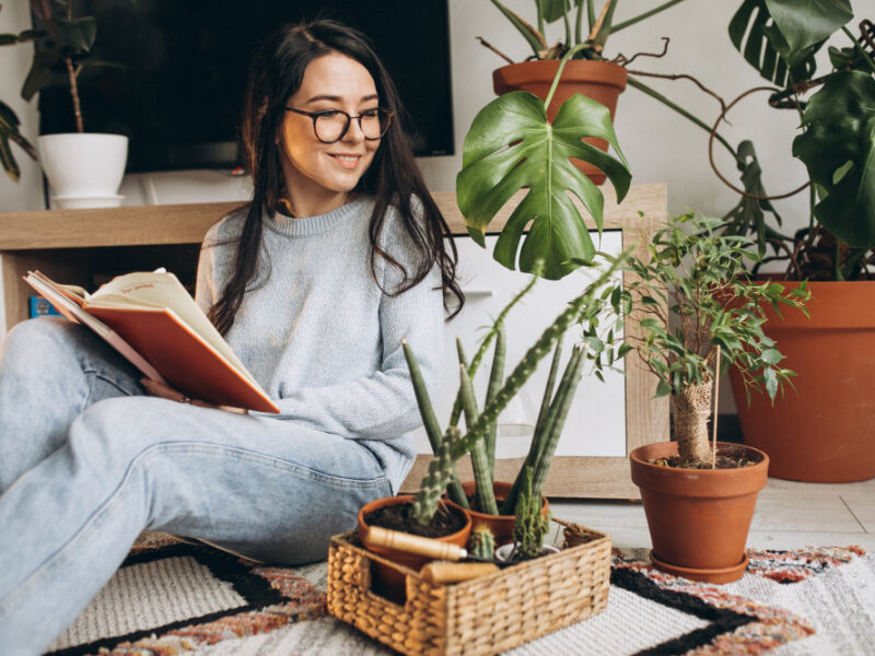 Young Woman Cultivating Plants Home