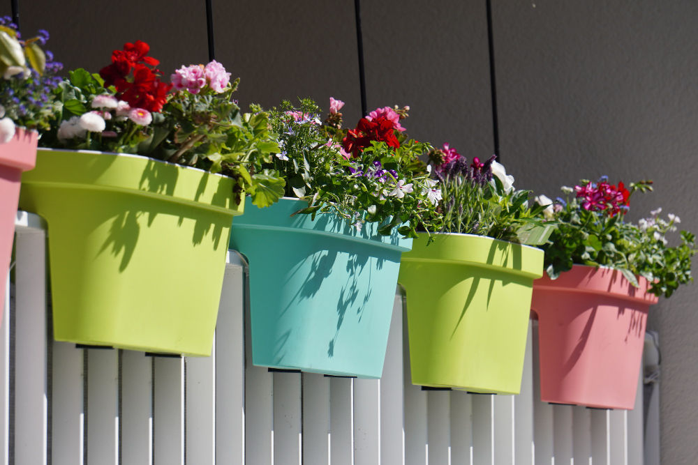Flowers With Colorful Pots White Fence