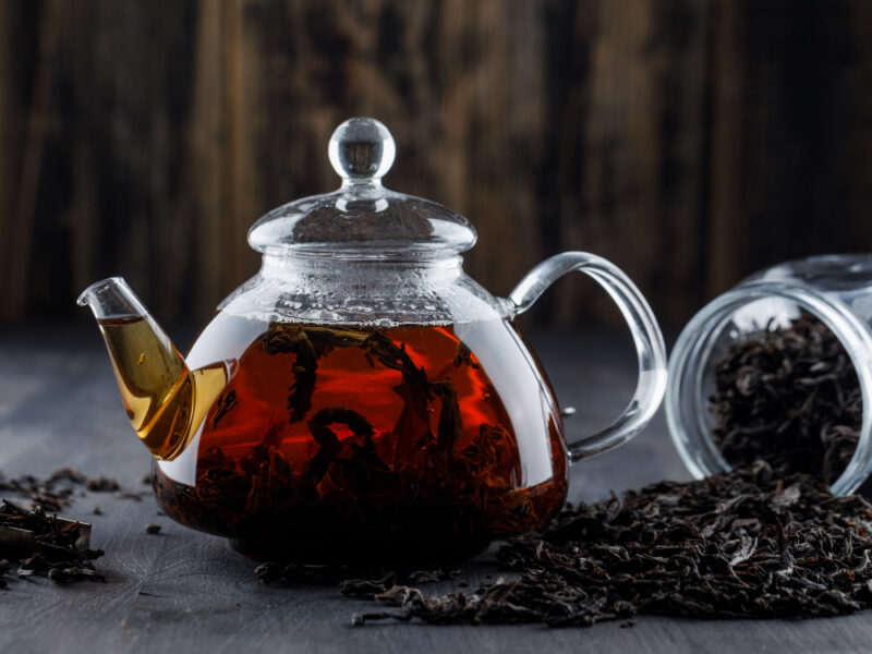 Black Tea With Dry Tea Teapot Wooden Surface Side View