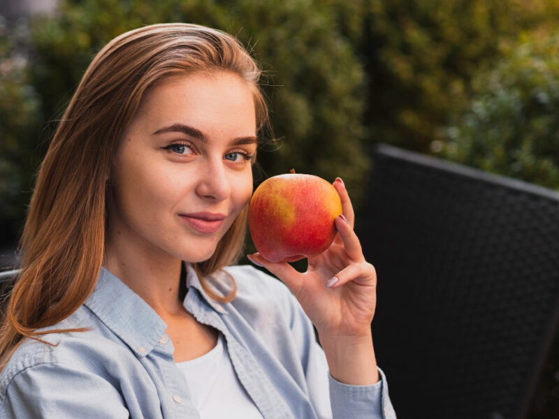 Portrait Blonde Woman Holding Apple