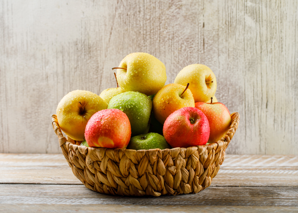 apples-with-drops-wicker-basket-light-wooden-grunge