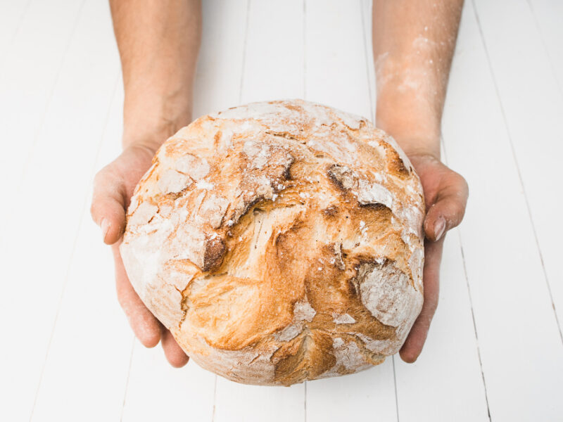 Closeup Male Hands Put Fresh Bread Old Rustic Table Black Background With Copy Space Your Text