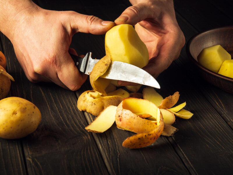 Peeling Potatoes Kitchen By Hands Chef With Knife Preparing National Dish