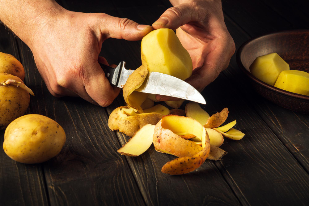 Peeling Potatoes Kitchen By Hands Chef With Knife Preparing National Dish