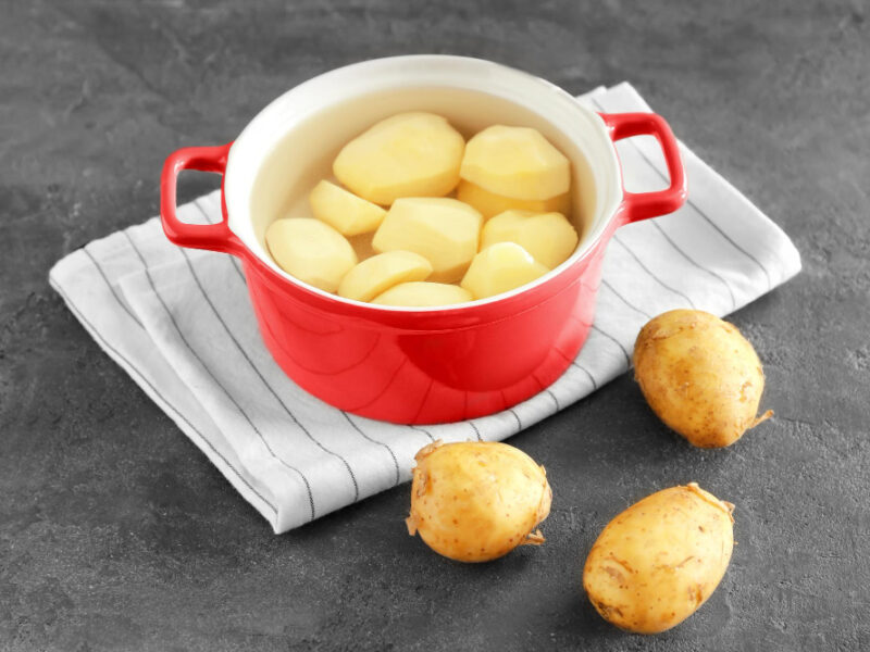 Cooking Pot With Raw Organic Potatoes Table