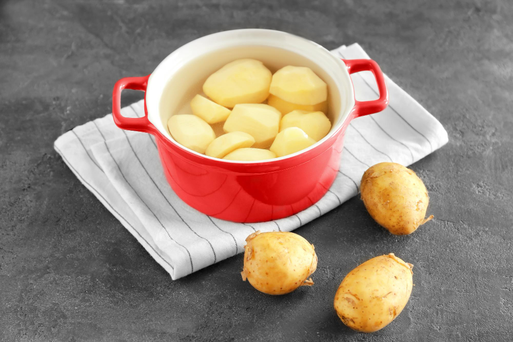 Cooking Pot With Raw Organic Potatoes Table