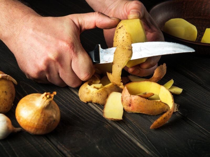 Peeling Potatoes Kitchen By Hands Cook With Knife Preparing National Dish