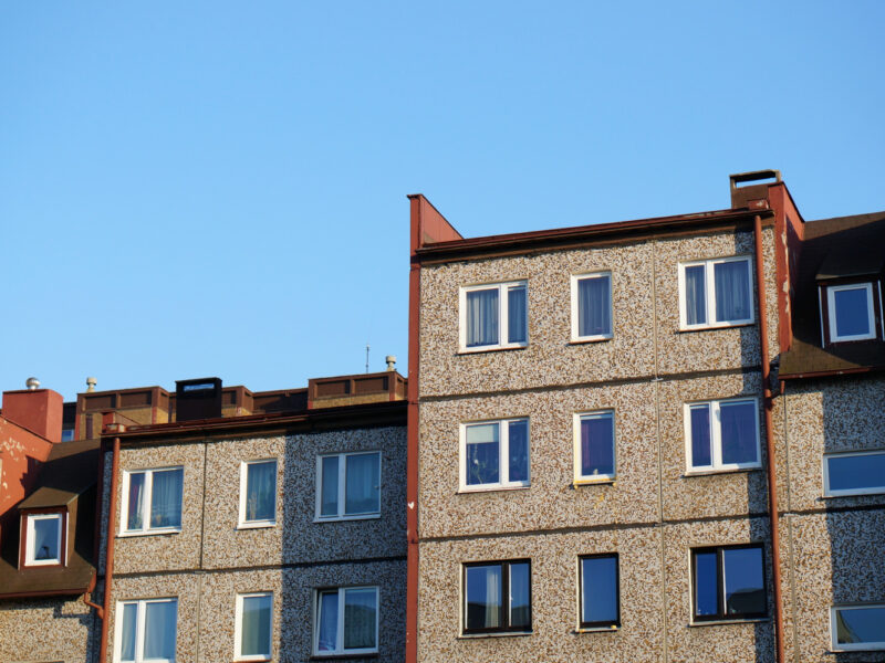 Facade Row Apartment Buildings Against Clear Blue Sky