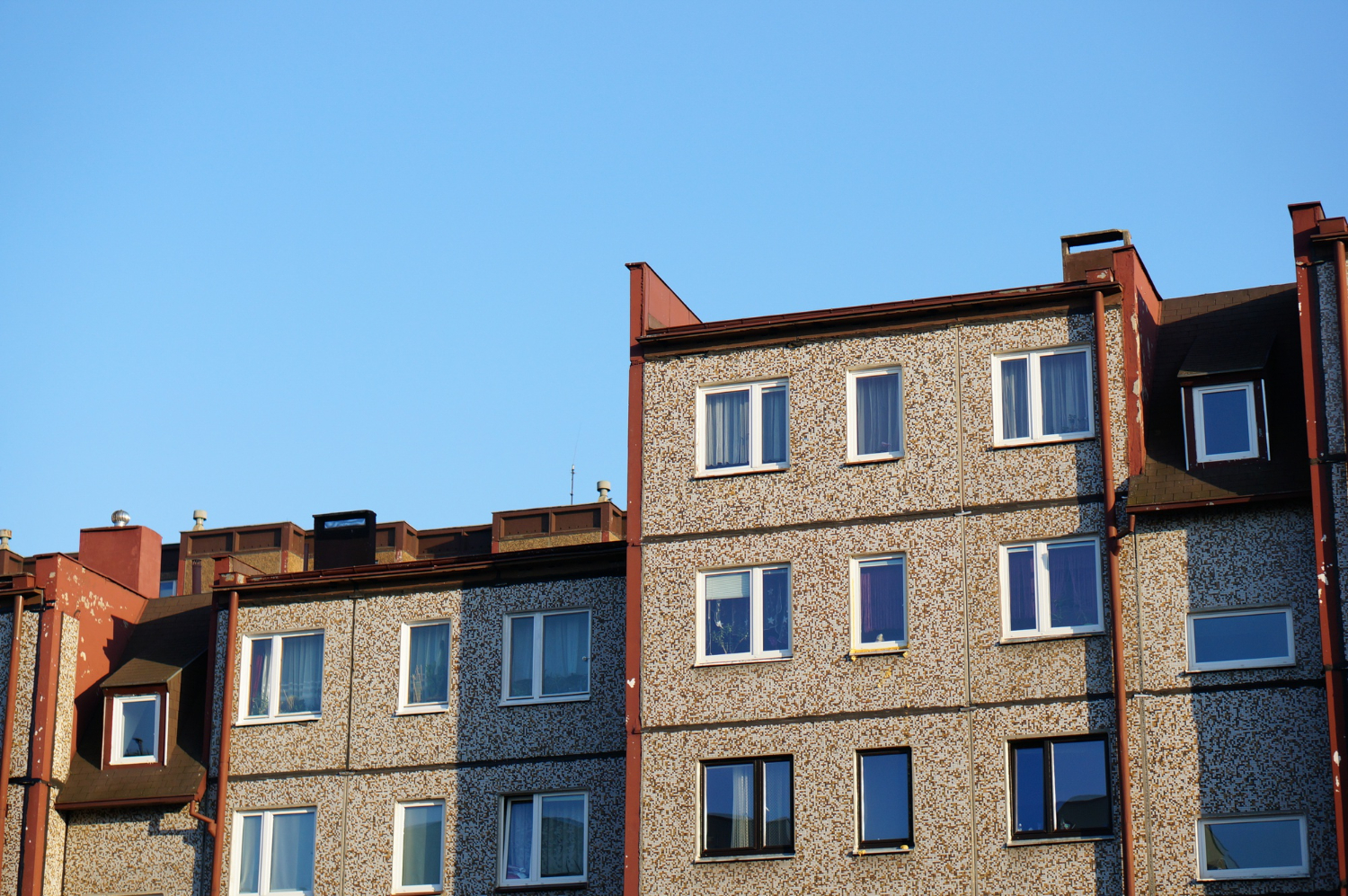 Facade Row Apartment Buildings Against Clear Blue Sky