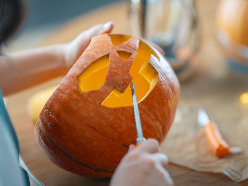 Woman Is Carving Pumpkin