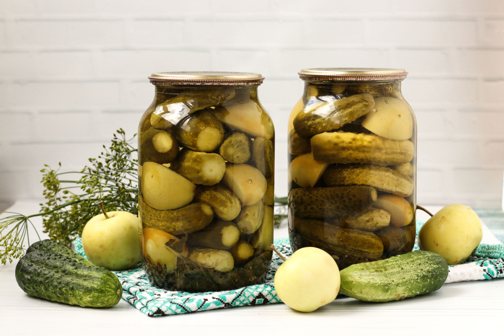 Marinated Cucumbers With Apples Jars Are Arranged White Background