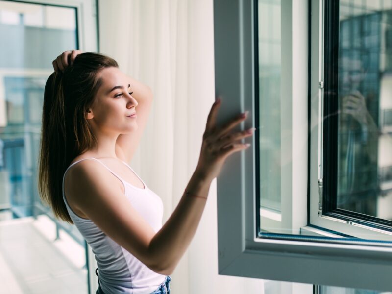 Woman Opens A Plastic Window And Smiling