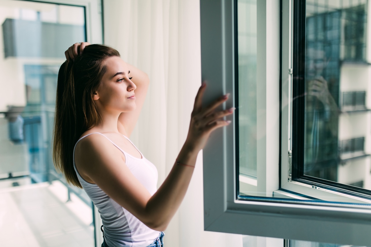 Woman Opens A Plastic Window And Smiling