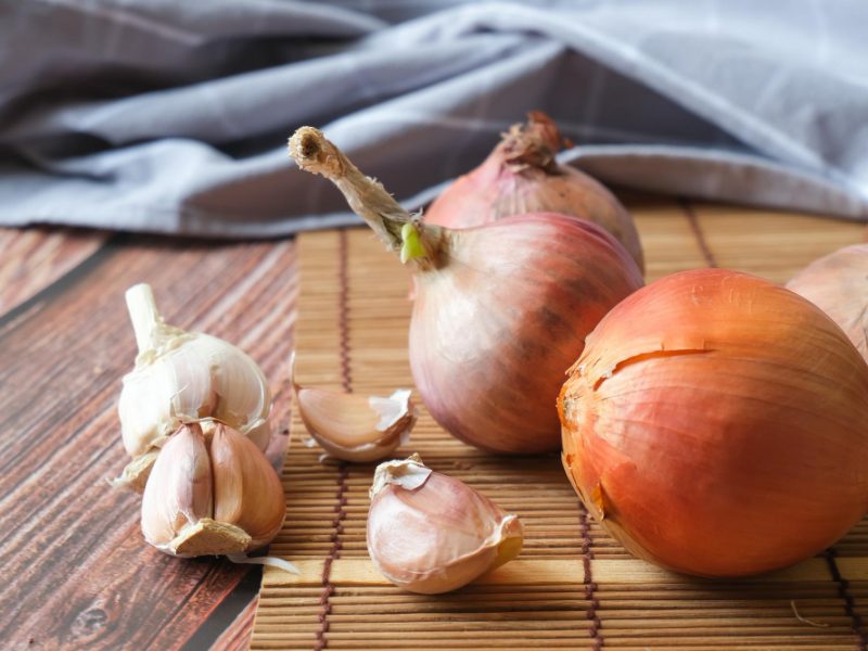 Onion Garlic Cloves With Wooden Texture Background