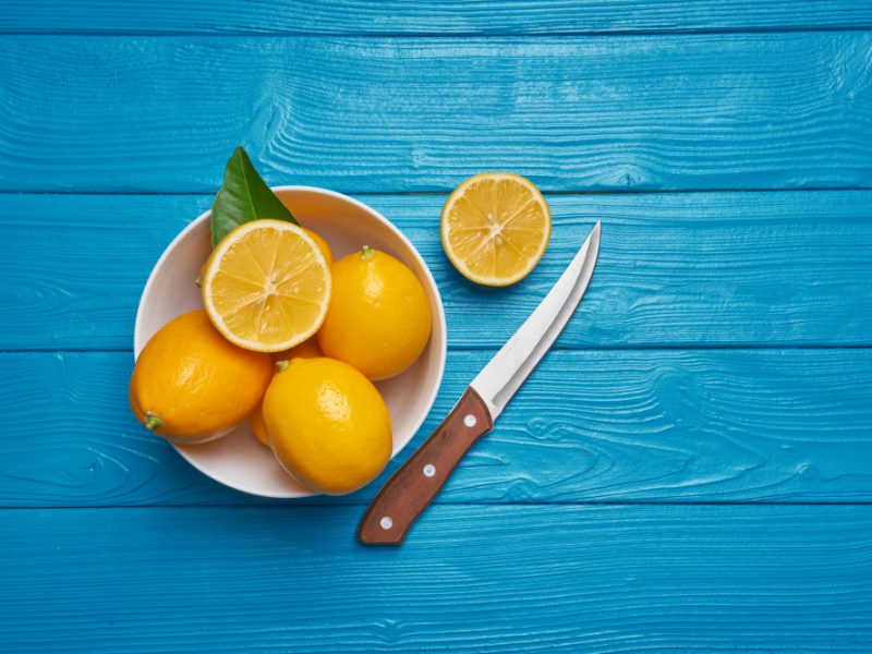 Fresh Ripe Lemons Knife Blue Wooden Table Top View With Copy Space