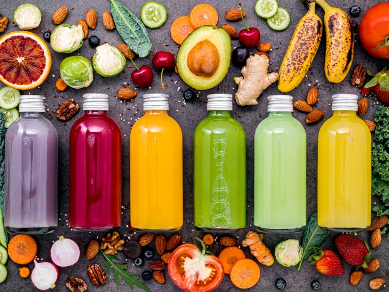 Colorful Healthy Smoothies Juices Bottles With Fresh Tropical Fruit Superfoods Dark Stone