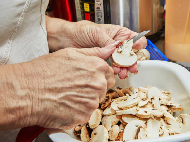 Woman Cuts Mushrooms Wooden Cutting Board Cooks According Recipe Home Kitchen