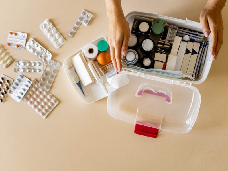 Closeup Female Hand Placing Medicament Domestic First Aid Kit Storage Organization Emergency Supply