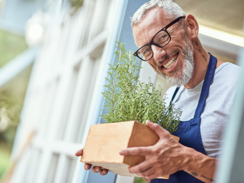 Middle Aged Caucasian Man Holding Box With Spicy Herbs
