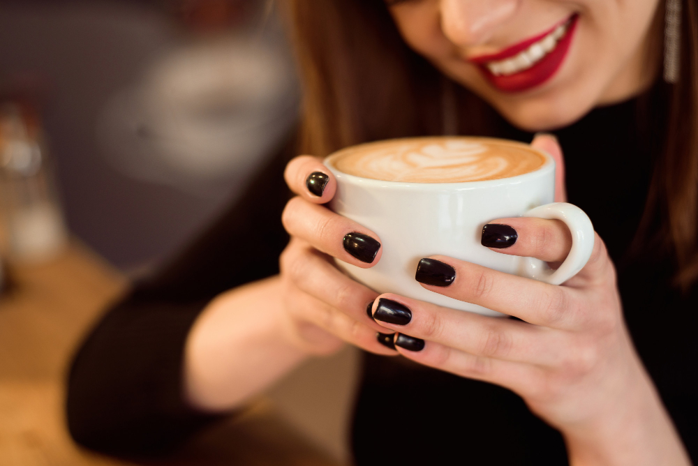 smiling-woman-good-mood-enjoy-cup-coffee-sitting-cafe