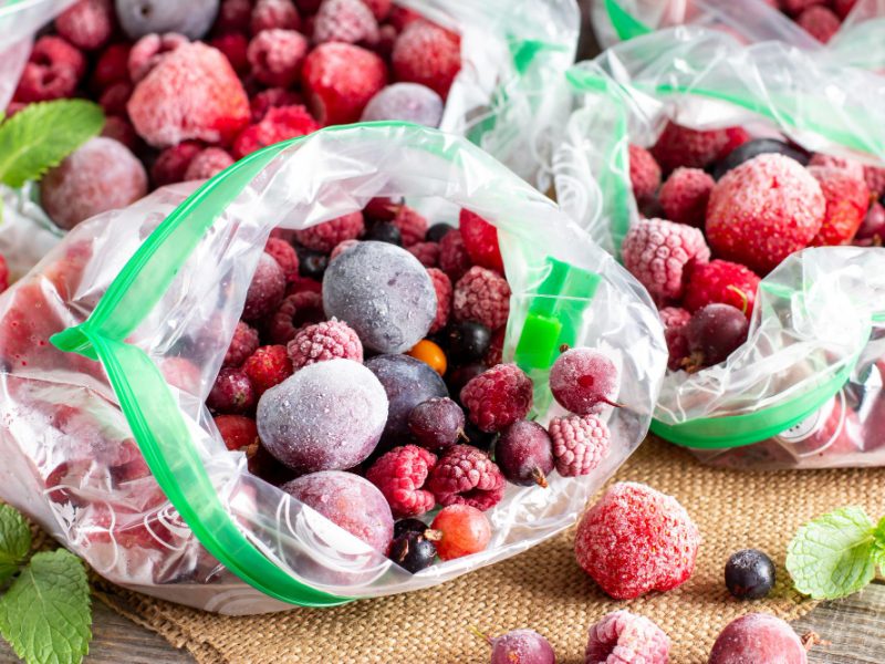 Frozen Berries Black Currant Red Currant Blackberry Blueberry Raspberry Strawberry Cherry Plum Plastic Bag Wooden Table Frozen Food