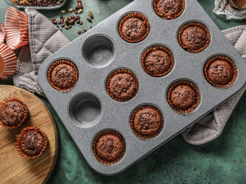 Baking Tin With Tasty Chocolate Muffins Table