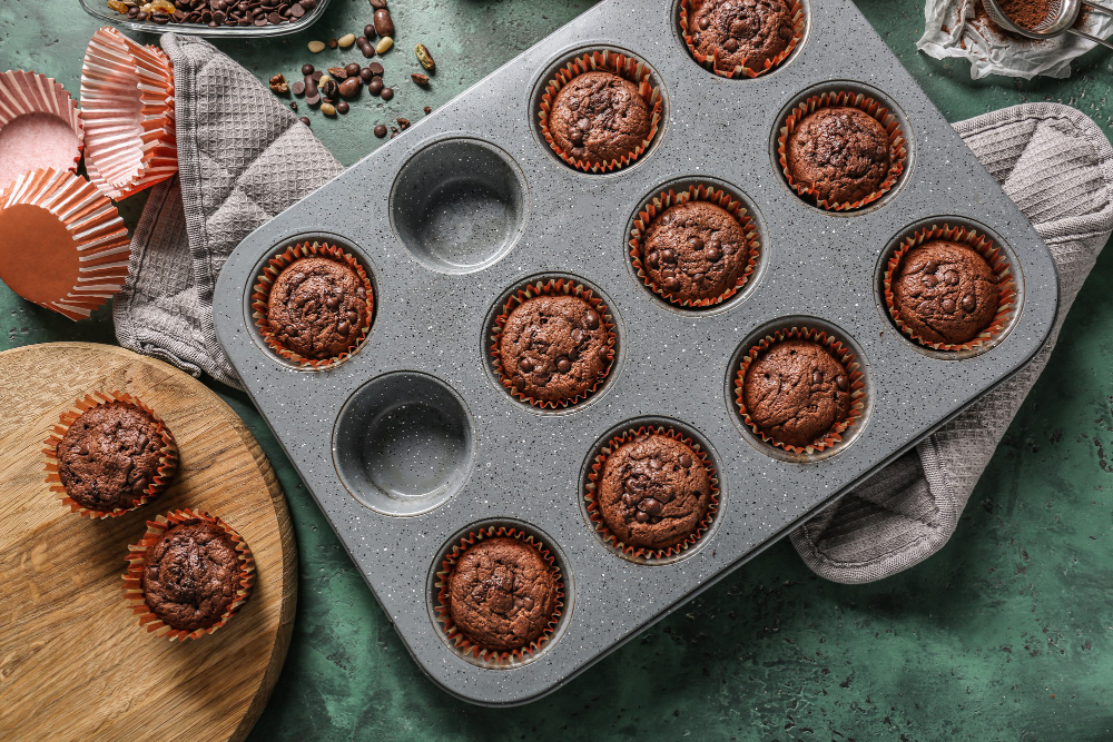 baking-tin-with-tasty-chocolate-muffins-table