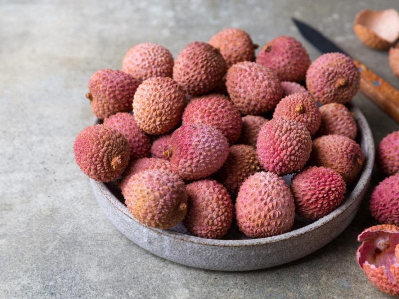 fresh-lychee-fruit-plate-grey-background-copy-space