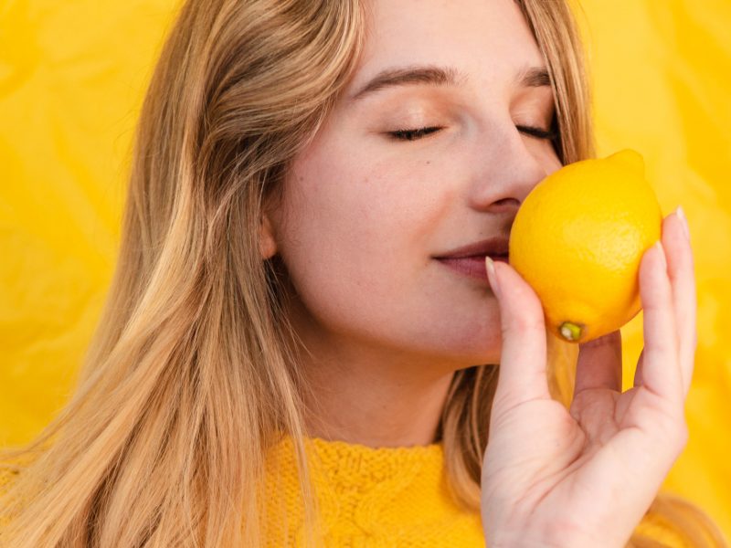 Close Up Woman Smelling Lemon