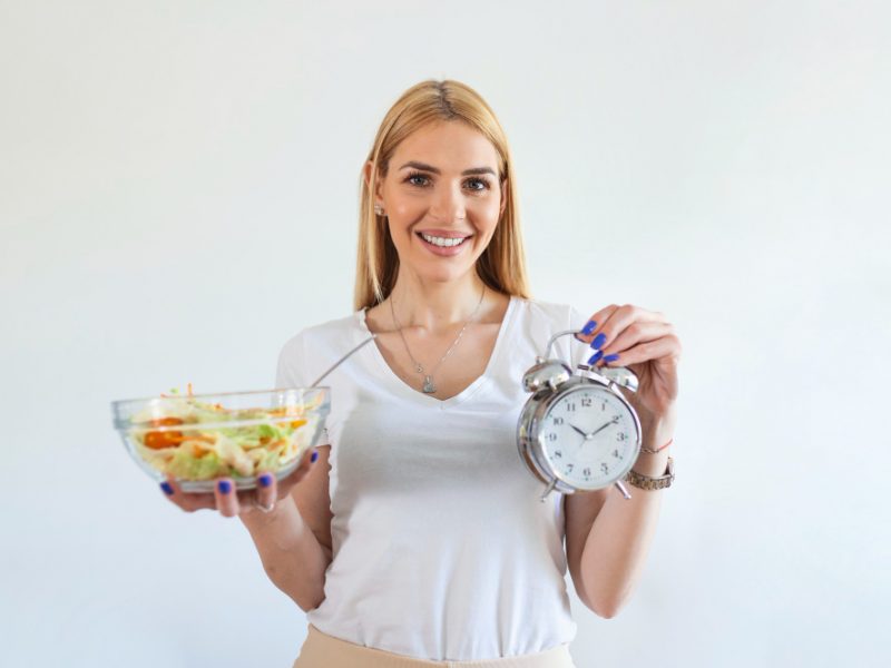 Young Woman Holding Clock Healthy Food Salad Intermittent Fasting Concept Time Lose Weight Eating Control Time Diet Concept